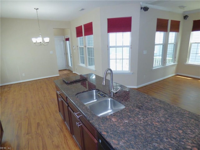 521 Simpson Ln, Chesapeake, VA 23323 - kitchen featuring a sink, light wood-style floors, a chandelier, and healthy amount of natural light