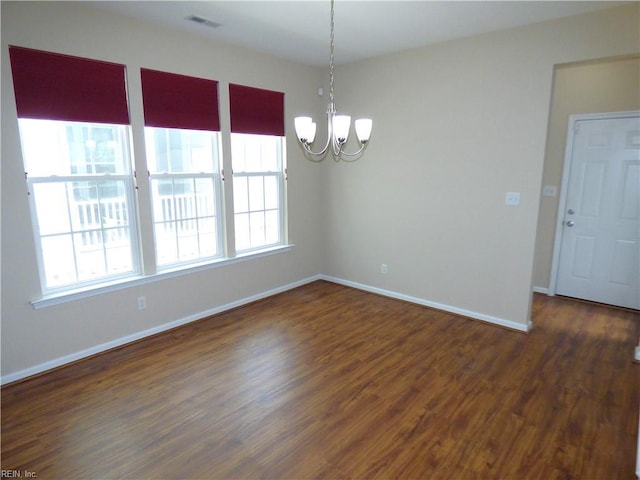 521 Simpson Ln, Chesapeake, VA 23323 - empty room with a chandelier, healthy amount of natural light, baseboards, and wood finished floors