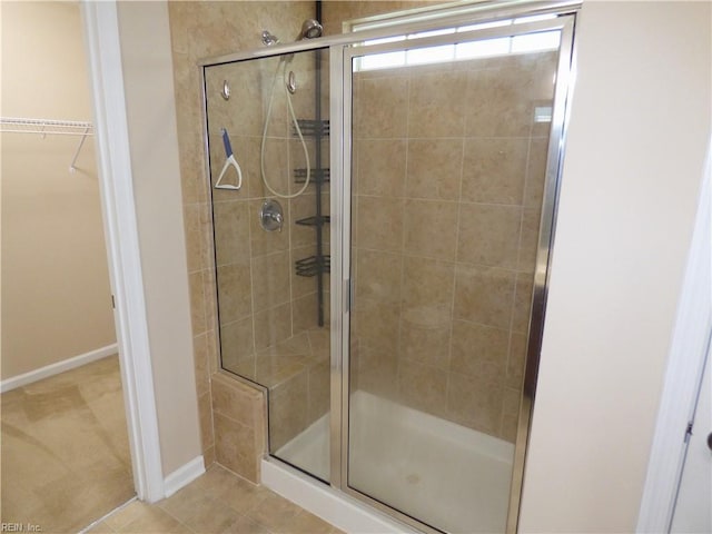 521 Simpson Ln, Chesapeake, VA 23323 - bathroom with a shower stall, a walk in closet, baseboards, and tile patterned flooring