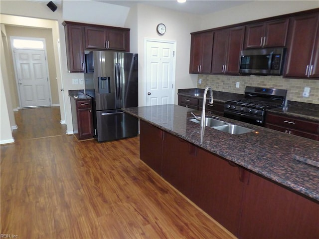 521 Simpson Ln, Chesapeake, VA 23323 - kitchen featuring appliances with stainless steel finishes, a sink, decorative backsplash, dark wood-style flooring, and dark stone countertops