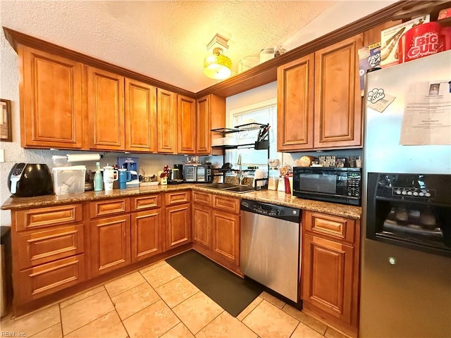 138 Ransone St, Hampton, VA 23669 - kitchen featuring appliances with stainless steel finishes, brown cabinets, and a textured ceiling