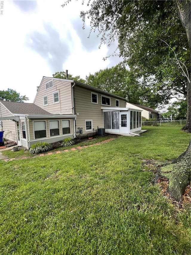 5972 Lockamy Ln, Norfolk, VA 23502 - rear view of property featuring a sunroom, a lawn, and central AC unit