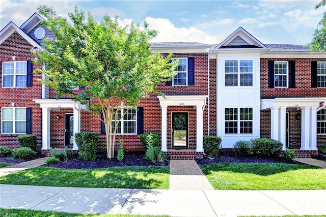 225 Quarterpath Rd, Williamsburg, VA 23185 - view of front facade with brick siding and a front lawn