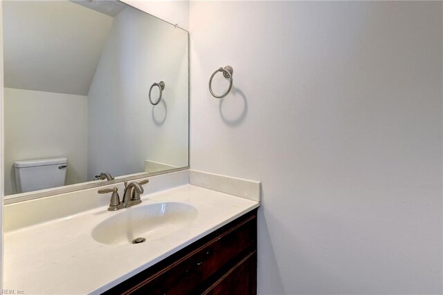 225 Quarterpath Rd, Williamsburg, VA 23185 - bathroom with vanity, toilet, and vaulted ceiling