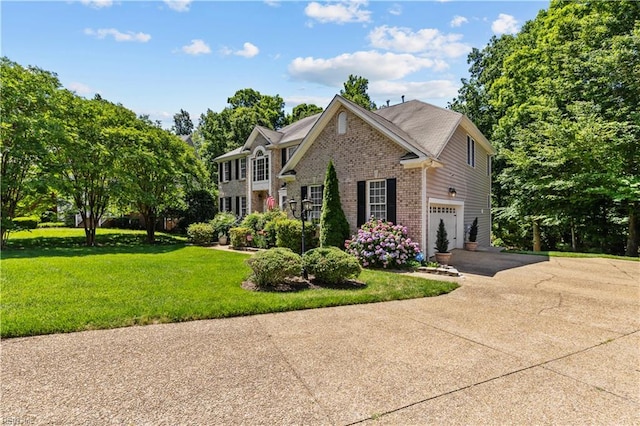 122 Merchant Man Ct, Williamsburg, VA 23185 - view of front of home with asphalt driveway, brick siding, a front yard, and a garage