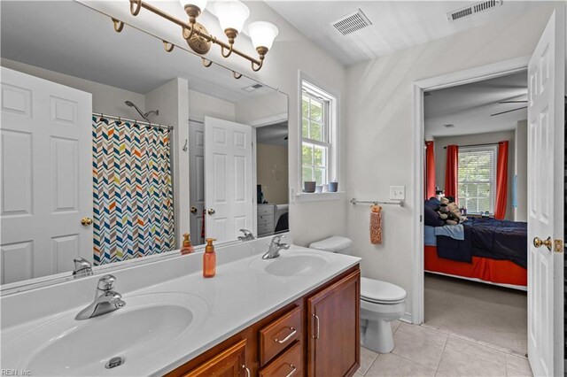 122 Merchant Man Ct, Williamsburg, VA 23185 - ensuite bathroom featuring tile patterned floors, toilet, double vanity, and curtained shower