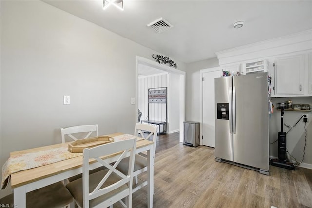 816 Colony Manor Rd, Chesapeake, VA 23321 - kitchen with stainless steel refrigerator with ice dispenser, light wood-style flooring, white cabinets, and baseboards