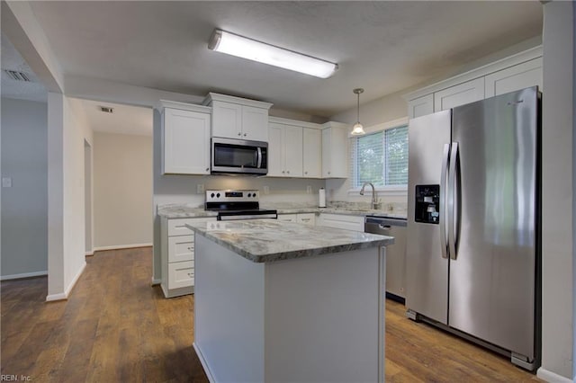 3096 Kenelm Dr, Chesapeake, VA 23323 - kitchen with stainless steel appliances, white cabinets, a kitchen island, and light stone counters