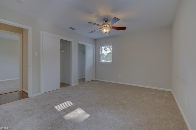 3096 Kenelm Dr, Chesapeake, VA 23323 - unfurnished bedroom featuring light colored carpet, two closets, baseboards, and a ceiling fan
