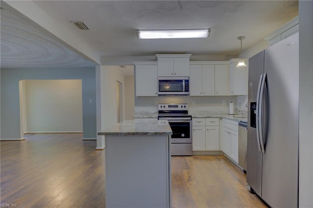 3096 Kenelm Dr, Chesapeake, VA 23323 - kitchen featuring stainless steel appliances, light wood-type flooring, a kitchen island, white cabinets, and light stone counters