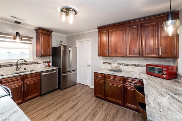 2617 Killey Ct, Virginia Beach, VA 23453 - kitchen featuring appliances with stainless steel finishes, a sink, decorative backsplash, decorative light fixtures, and ornamental molding
