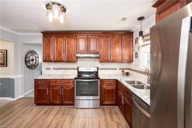 2617 Killey Ct, Virginia Beach, VA 23453 - kitchen with stainless steel appliances, under cabinet range hood, a sink, light wood-style floors, and tasteful backsplash