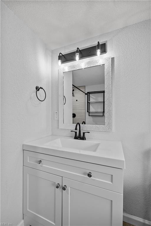 1305 Canary Dr, Virginia Beach, VA 23453 - bathroom featuring vanity, a textured wall, baseboards, and a textured ceiling