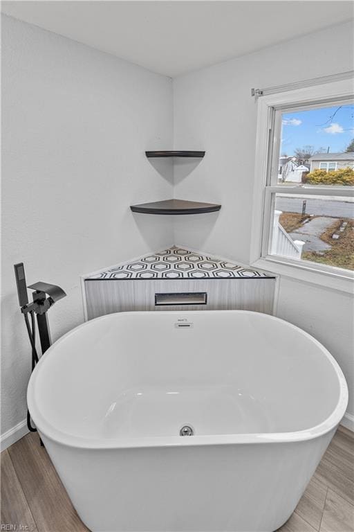 1305 Canary Dr, Virginia Beach, VA 23453 - bathroom with a freestanding tub, wood finished floors, and baseboards