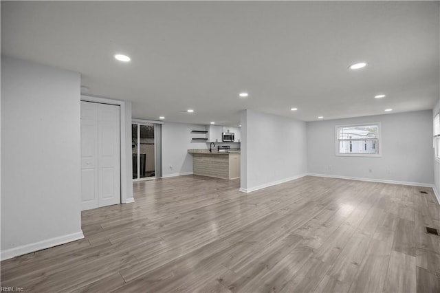 1305 Canary Dr, Virginia Beach, VA 23453 - unfurnished living room with baseboards, recessed lighting, and light wood-type flooring