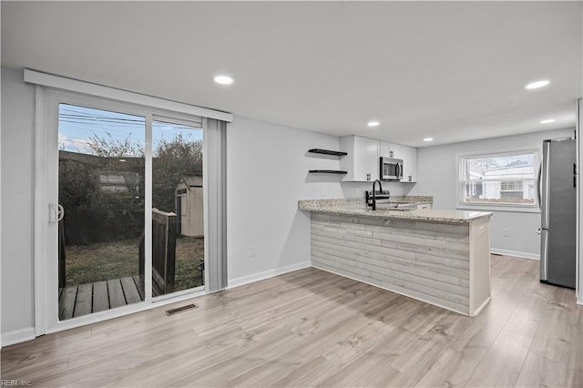 1305 Canary Dr, Virginia Beach, VA 23453 - kitchen featuring stainless steel appliances, open shelves, white cabinetry, a peninsula, and baseboards
