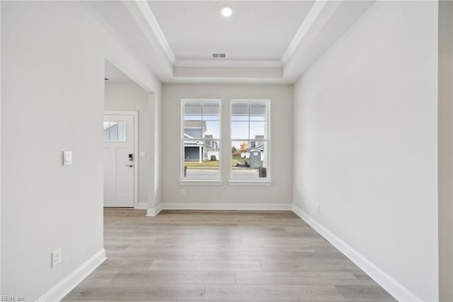 2142 Edwin Dr, Chesapeake, VA 23322 - empty room with ornamental molding, light wood finished floors, a tray ceiling, and baseboards