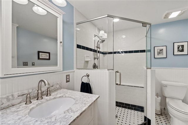 3321 Tyre Neck Rd, Chesapeake, VA 23321 - bathroom featuring a wainscoted wall, toilet, vanity, a stall shower, and tile patterned floors