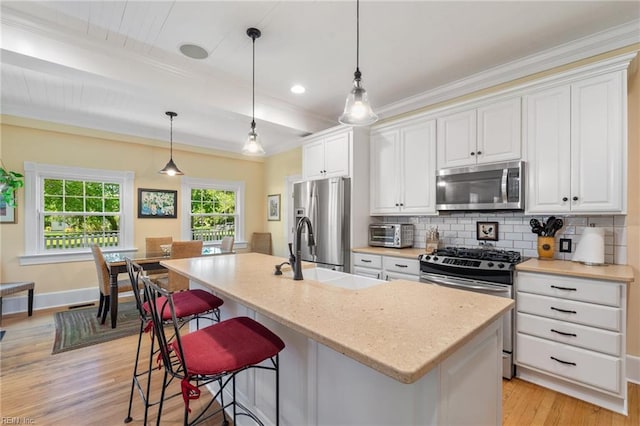 3321 Tyre Neck Rd, Chesapeake, VA 23321 - kitchen with appliances with stainless steel finishes, a sink, light wood-style floors, backsplash, and a kitchen breakfast bar