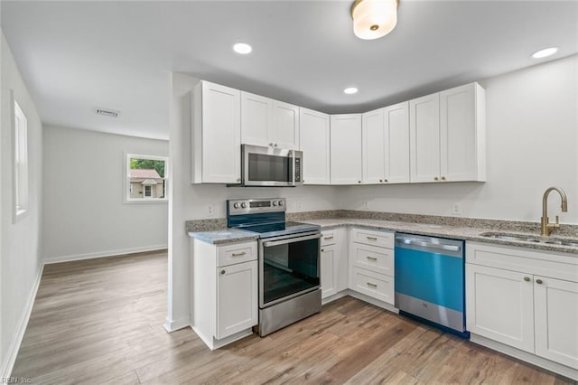 436 Smiley Rd, Hampton, VA 23663 - kitchen featuring stainless steel appliances, a sink, light wood-style flooring, white cabinets, and recessed lighting