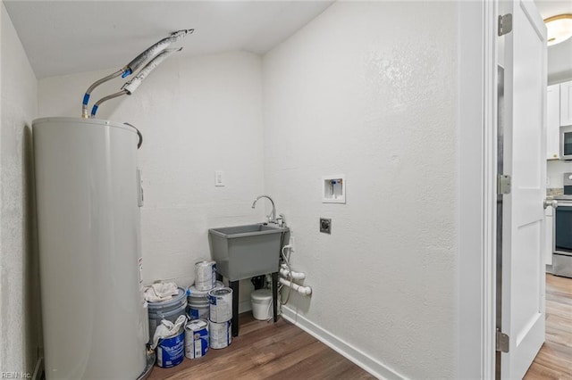 436 Smiley Rd, Hampton, VA 23663 - laundry area with water heater, hookup for a washing machine, wood finished floors, and a textured wall