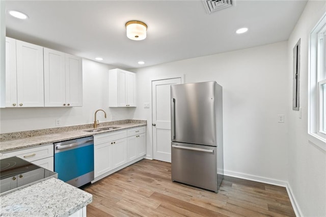 436 Smiley Rd, Hampton, VA 23663 - kitchen featuring freestanding refrigerator, dishwasher, a sink, white cabinetry, and light wood-style floors