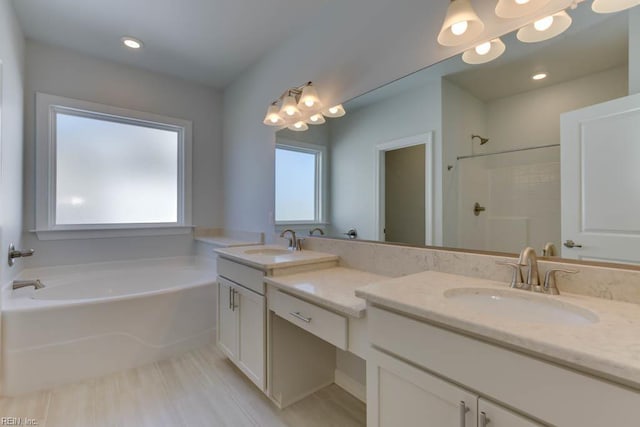 2246 Captiva Ln, Chesapeake, VA 23321 - bathroom featuring a garden tub, double vanity, a shower, and recessed lighting