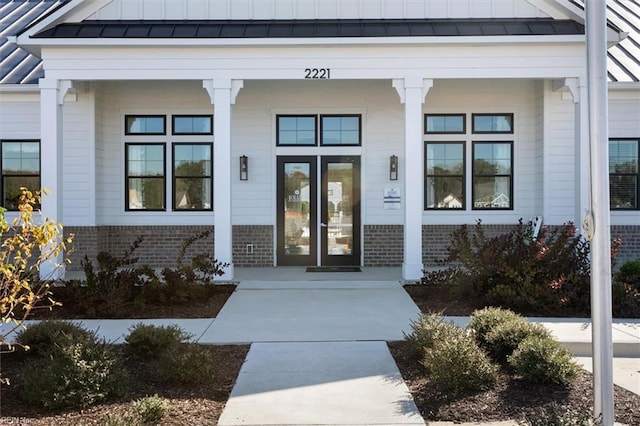 2246 Captiva Ln, Chesapeake, VA 23321 - entrance to property featuring brick siding, a standing seam roof, covered porch, and metal roof