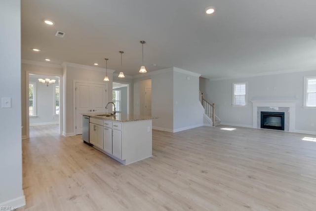 2246 Captiva Ln, Chesapeake, VA 23321 - kitchen featuring a sink, ornamental molding, stainless steel dishwasher, a center island with sink, and a fireplace