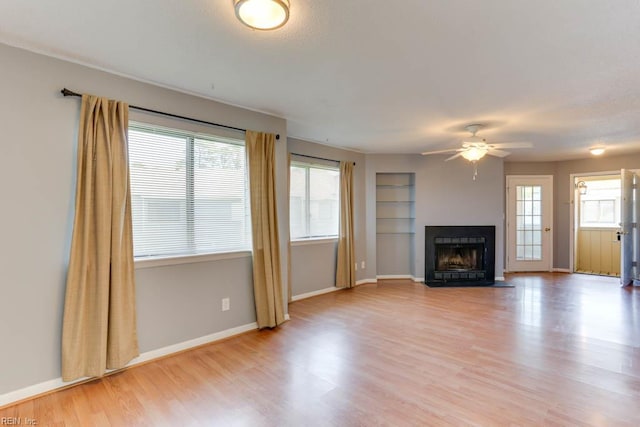 2922 Lyme Regis Quay Quay, Virginia Beach, VA 23452 - unfurnished living room featuring light wood-style flooring, ceiling fan, a fireplace with flush hearth, and baseboards