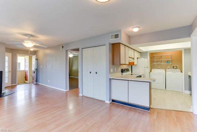 2922 Lyme Regis Quay Quay, Virginia Beach, VA 23452 - kitchen with washer and dryer, freestanding refrigerator, a ceiling fan, light wood-style floors, and light countertops