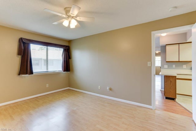 2922 Lyme Regis Quay Quay, Virginia Beach, VA 23452 - empty room with light wood finished floors, a ceiling fan, a smoke detector, and baseboards