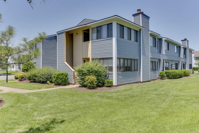 2922 Lyme Regis Quay Quay, Virginia Beach, VA 23452 - view of side of property with a chimney and a lawn