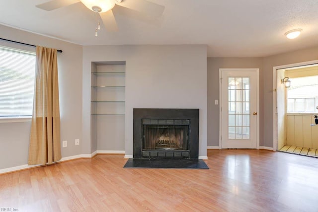 2922 Lyme Regis Quay Quay, Virginia Beach, VA 23452 - unfurnished living room with wood finished floors, plenty of natural light, and a fireplace with flush hearth