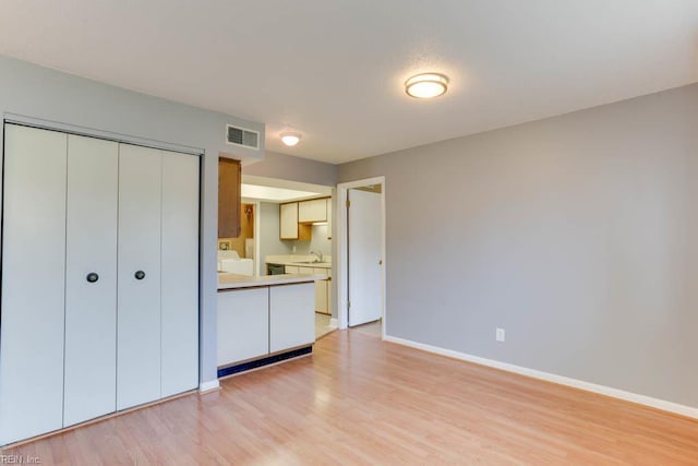 2922 Lyme Regis Quay Quay, Virginia Beach, VA 23452 - unfurnished bedroom with light wood finished floors, baseboards, and a closet
