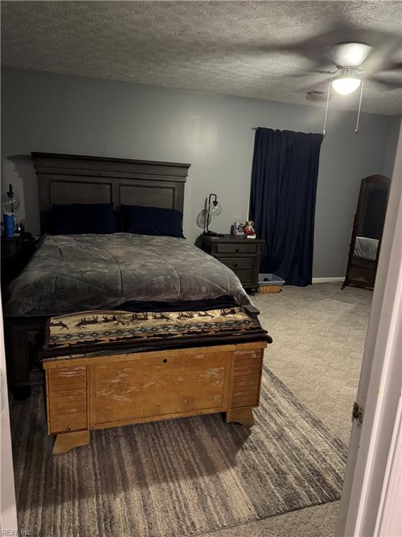412 Joseph Topping Dr, Poquoson, VA 23662 - bedroom with dark colored carpet, a textured ceiling, and ceiling fan