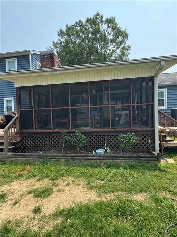 412 Joseph Topping Dr, Poquoson, VA 23662 - back of house featuring a sunroom and a chimney