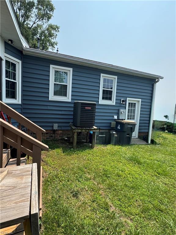 412 Joseph Topping Dr, Poquoson, VA 23662 - rear view of house with central air condition unit and a yard