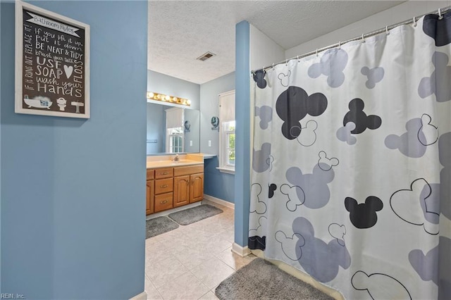 412 Joseph Topping Dr, Poquoson, VA 23662 - full bathroom featuring vanity, a textured ceiling, a shower with curtain, and tile patterned flooring