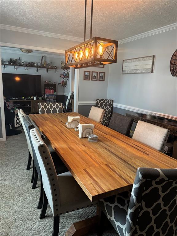 412 Joseph Topping Dr, Poquoson, VA 23662 - carpeted dining area with a textured ceiling and crown molding