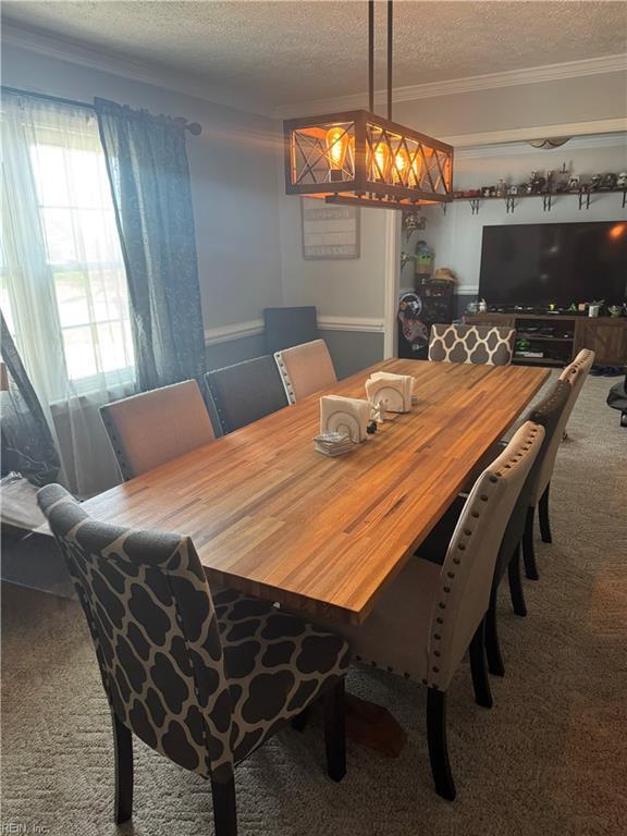 412 Joseph Topping Dr, Poquoson, VA 23662 - carpeted dining space with a textured ceiling and crown molding