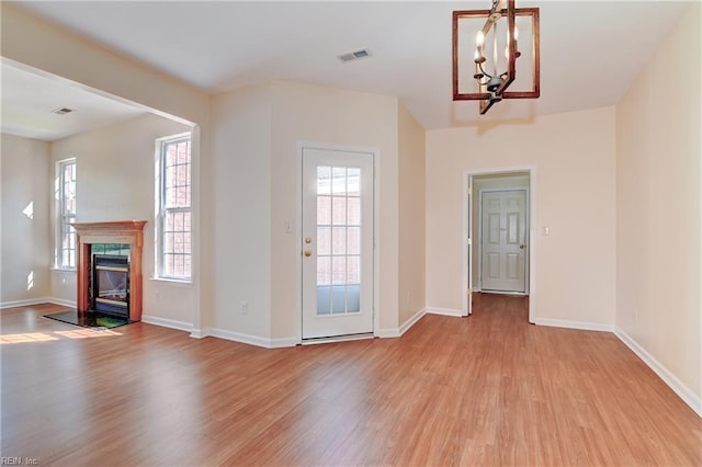 735 Great Marsh Ave, Chesapeake, VA 23320 - unfurnished living room with light wood-style flooring, a chandelier, and baseboards
