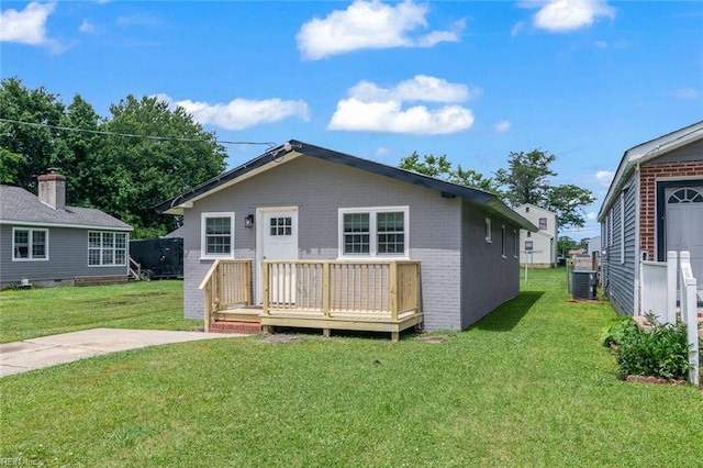 1304 Quash St, Hampton, VA 23669 - view of front of home featuring a front yard, a deck, central air condition unit, and brick siding