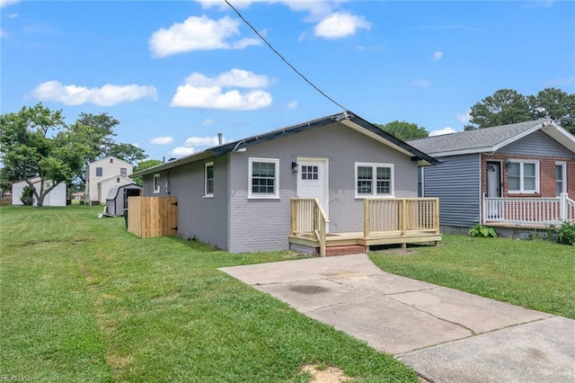 1304 Quash St, Hampton, VA 23669 - view of front of home with a wooden deck, a front yard, and brick siding