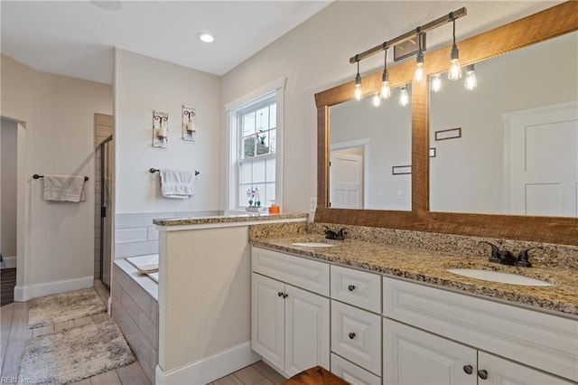 115 Cooks Landing Rd, Camden, NC 27921 - bathroom with a stall shower, double vanity, a bath, and baseboards