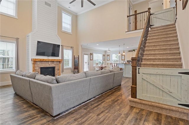 115 Cooks Landing Rd, Camden, NC 27921 - living area featuring crown molding, a fireplace, ceiling fan, dark wood-style floors, and stairway