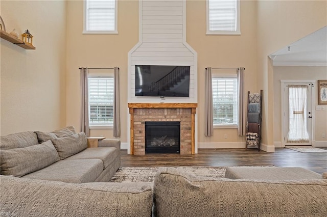 115 Cooks Landing Rd, Camden, NC 27921 - living room featuring wood finished floors, crown molding, a brick fireplace, and baseboards