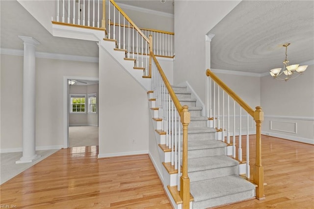 3353 Star Creek Ct, Suffolk, VA 23435 - stairs featuring decorative columns, wood finished floors, ornamental molding, and a chandelier