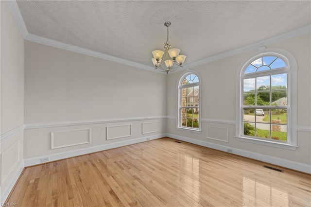 3353 Star Creek Ct, Suffolk, VA 23435 - empty room with a chandelier, wood finished floors, a wainscoted wall, and ornamental molding