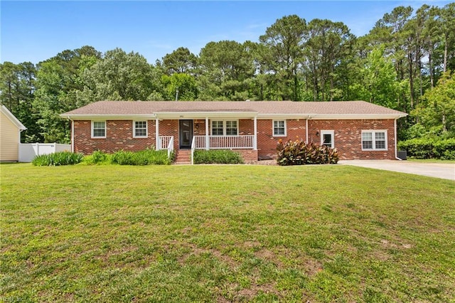 4901 Lake Shore Dr, Chesapeake, VA 23321 - ranch-style house featuring a porch, brick siding, and view of wooded area